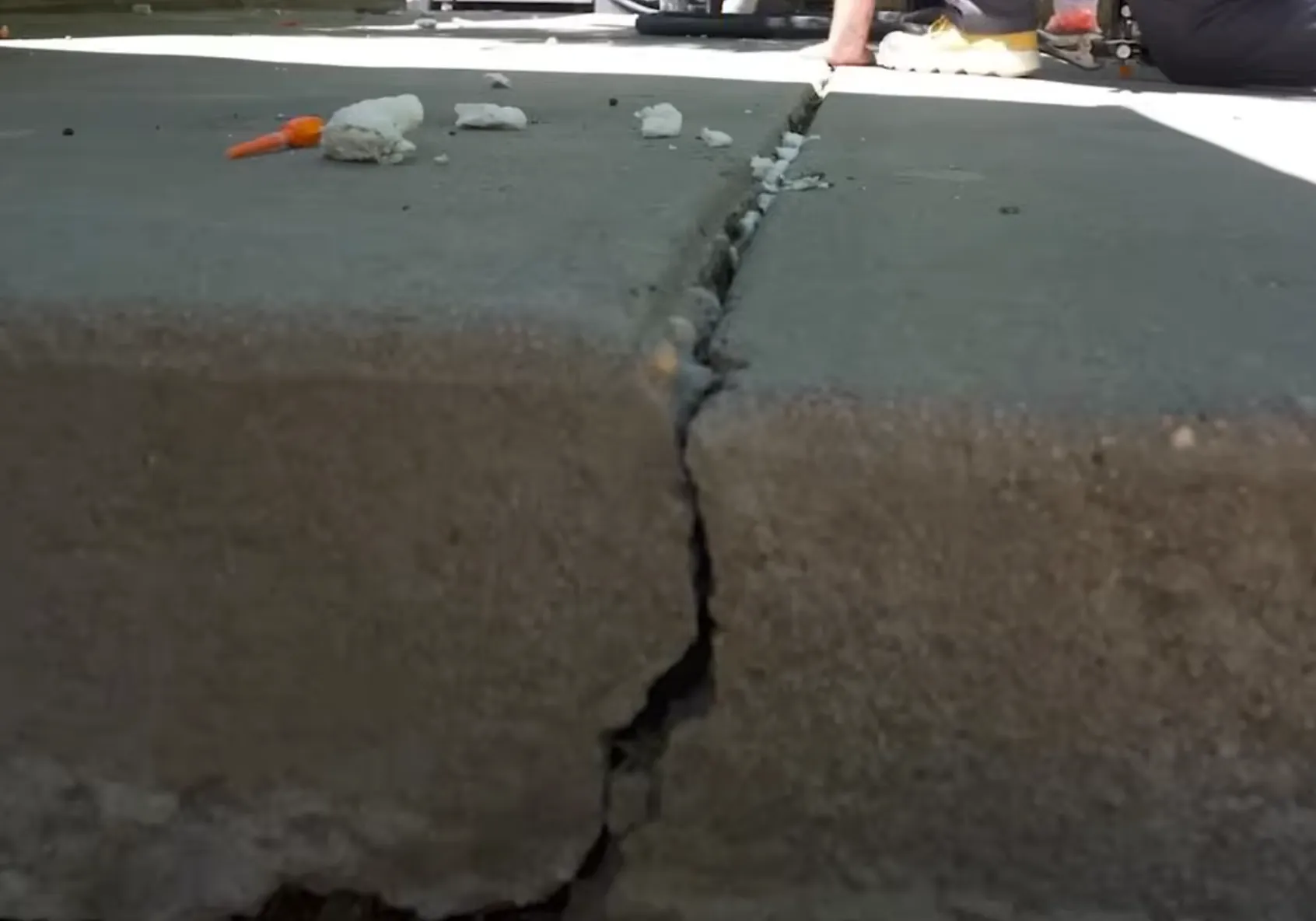 Before concrete leveling: sunken driveway panel